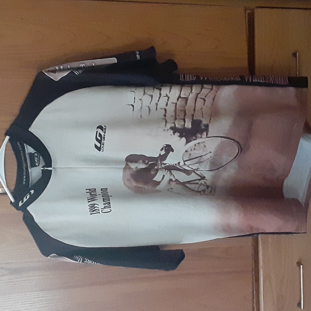 A beige cream and black biker shirt in good condition ready for u to sport